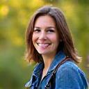 Successful photography graduate Sarah J holding her camera